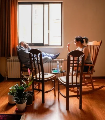 People relax in a cozy living room setting.