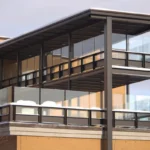 A tall building with a metal balcony on top of it