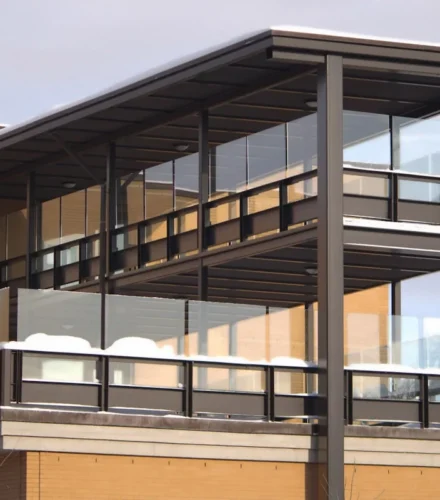 A tall building with a metal balcony on top of it