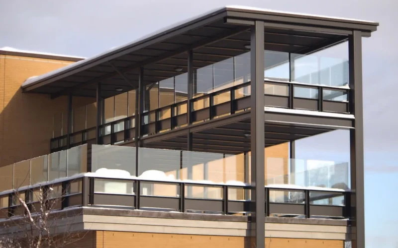 A tall building with a metal balcony on top of it