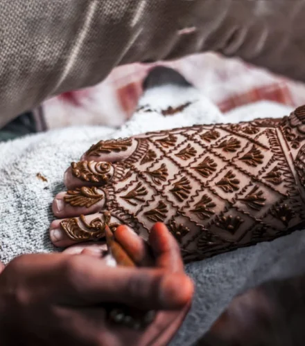 person with foot mendhi tattoo