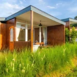 A small house sitting on top of a lush green field