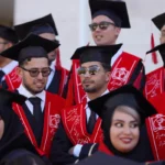 Graduates celebrate their commencement in traditional attire.