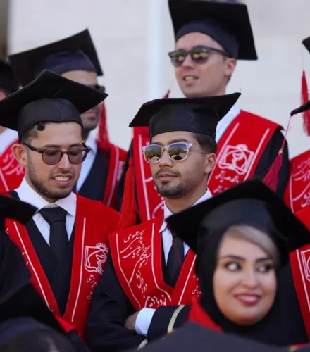 Graduates celebrate their commencement in traditional attire.