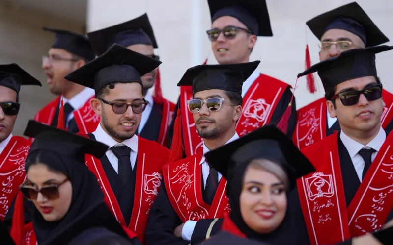 Graduates celebrate their commencement in traditional attire.