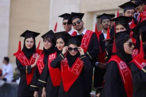 Graduates pose proudly in their gowns and caps.