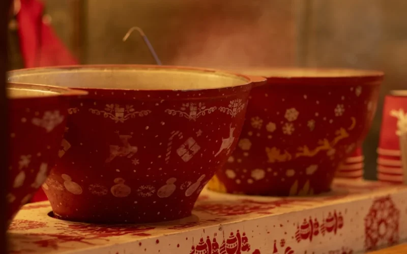 a row of red bowls sitting on top of a shelf
