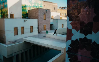 Man runs across a bridge in an urban setting.