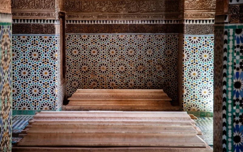 Ornate tiled walls and wooden steps inside building