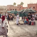 a group of people standing and sitting in a courtyard