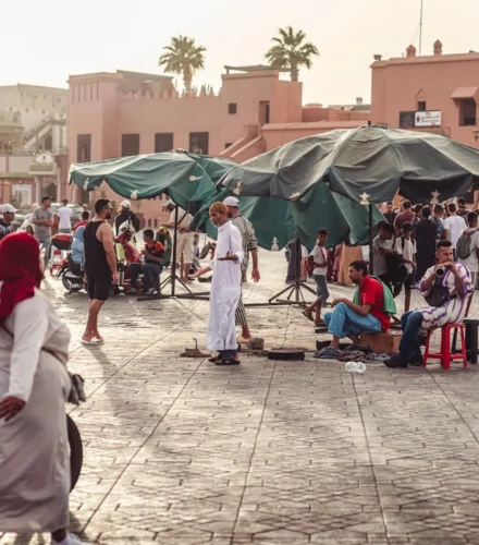 a group of people standing and sitting in a courtyard