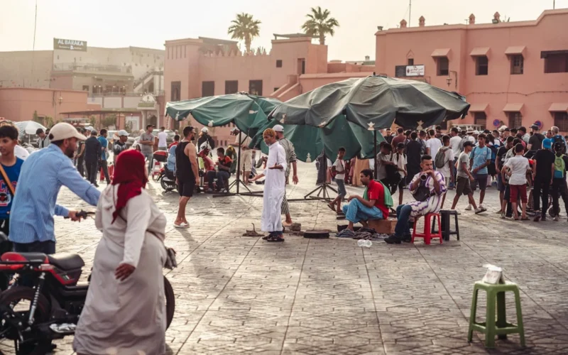 a group of people standing and sitting in a courtyard