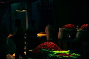 People working in a dimly lit flower market.