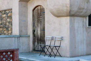 Two chairs in front of an old wooden door