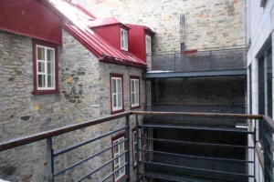 a building with a red roof and a balcony