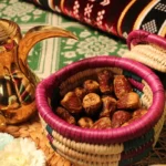 Dates in a woven basket with arabic coffee pot