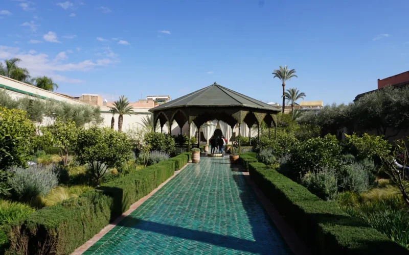 people walking on pathway near white concrete building during daytime