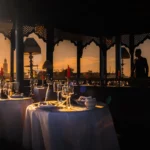 a couple of tables that have some wine glasses on them