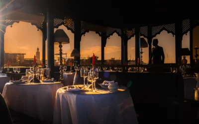 a couple of tables that have some wine glasses on them