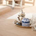 We travelled Marokko in 2010. Starting in Casablanca, we went on to Fès by train. We booked the Dar Bensouda from Casablanca and so we thought we knew where we had to go. Arriving at the Medina of Fès, it was impossible to find our way through the Medina. Many local people shouted and spat at us because we did not want to pay a local guy for taking our bags. After 1 hour walking through the extremely hot, narrow alleys, we decided to pay a local anyway and he brought us to our Riad. And that was a oasis in this crowdy Medina. Quiet, wonderful and the tea on the rooftop was gorgeous & relaxing