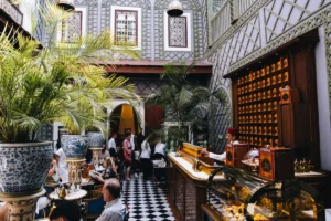 People in a moroccan-style courtyard cafe with plants and plants
