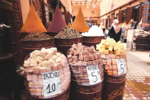 Spices and soaps displayed at an outdoor market.