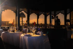 a couple of tables that have some wine glasses on them