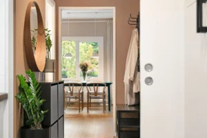 A hallway leading to a dining room and kitchen