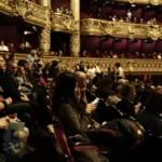people sitting on red chairs