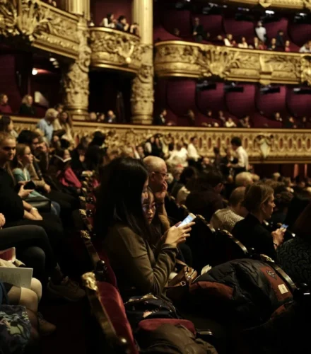 people sitting on red chairs