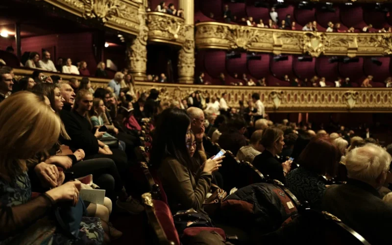 people sitting on red chairs