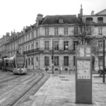 a black and white photo of a train on the tracks