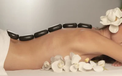 Woman getting a hot stone massage at spa salon