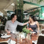 a man and woman sitting at a table in a restaurant
