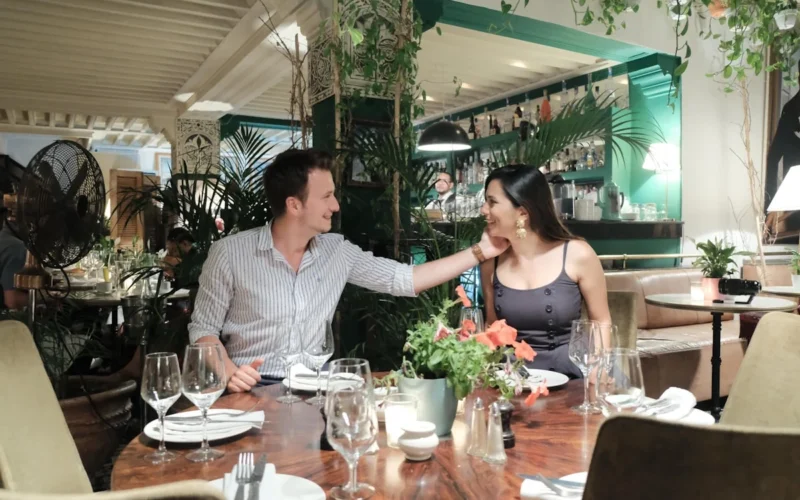 a man and woman sitting at a table in a restaurant