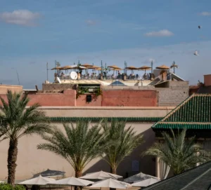 the roof of a building with tables and umbrellas