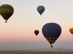 A group of hot air balloons flying in the sky