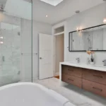 a bathroom with a large white bathtub next to a walk in shower