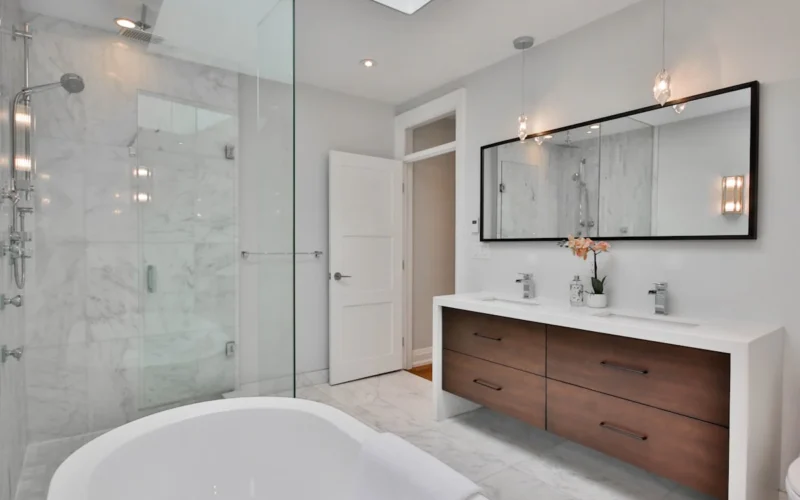 a bathroom with a large white bathtub next to a walk in shower