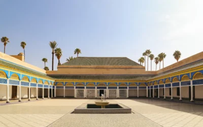 a courtyard with a fountain surrounded by palm trees