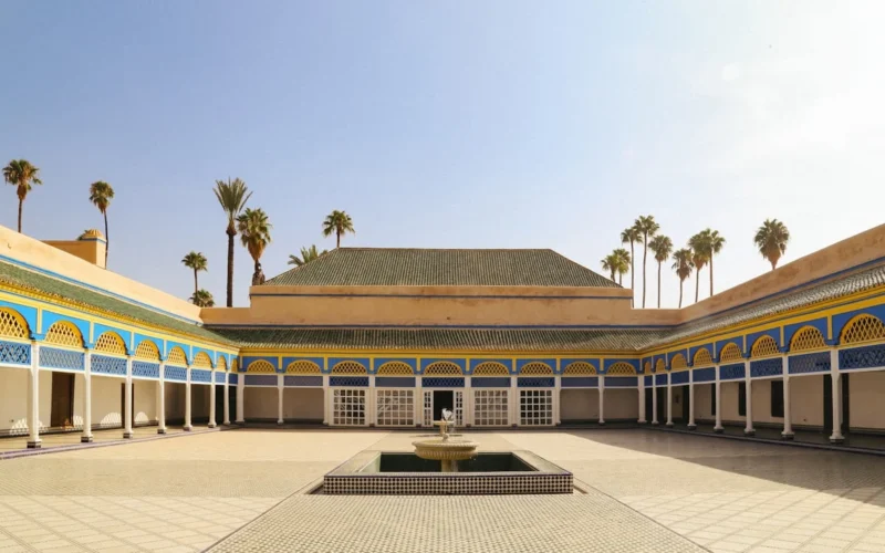 a courtyard with a fountain surrounded by palm trees