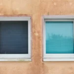Two windows on a textured wall
