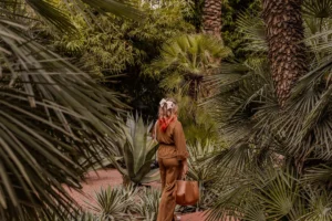 Woman walking through a lush green botanical garden.