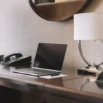 During a recent trip, I thought there might be a use for a “working in a hotel room” photo that wasn’t overdone. I wish I took my water bottle off the desk, but it kind of balances out the photo.