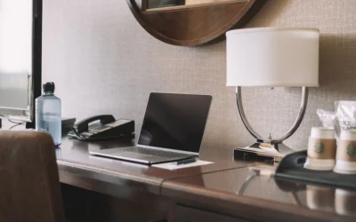 During a recent trip, I thought there might be a use for a “working in a hotel room” photo that wasn’t overdone. I wish I took my water bottle off the desk, but it kind of balances out the photo.