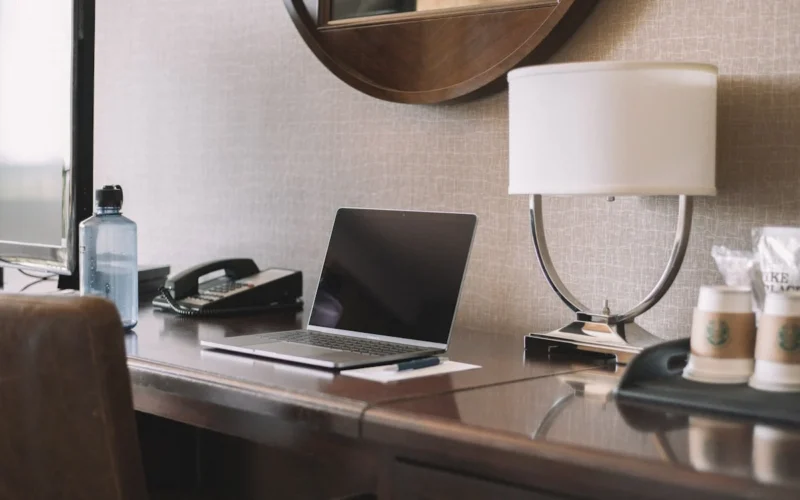 During a recent trip, I thought there might be a use for a “working in a hotel room” photo that wasn’t overdone. I wish I took my water bottle off the desk, but it kind of balances out the photo.