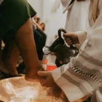a close up of a person pouring something into a bowl