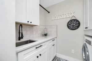 a laundry room with a sink and a washer and dryer