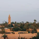 Moroccan minaret tower surrounded by palm trees