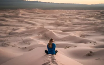 woman sitting on sand field